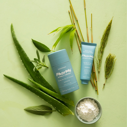 PhorMe unscented natural deodorant stick and whole body deodorant crème displayed with aloe vera, horsetail, bamboo, sage, and arrowroot powder on a light green background.